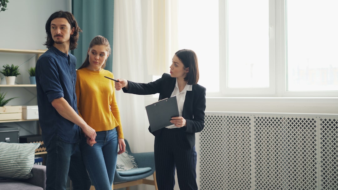 A group of people standing and talking in a modern living room